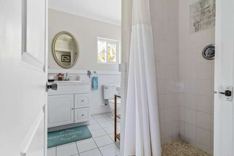 Bath with walk-in shower.