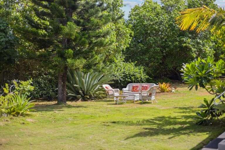Outdoor seating among the lush tropical vegetation.