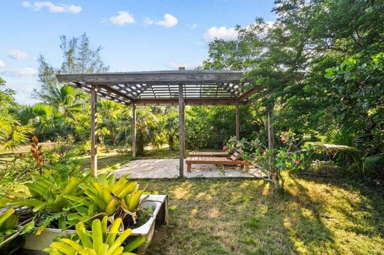 Relax under the outdoor cabana in the tropical garden.