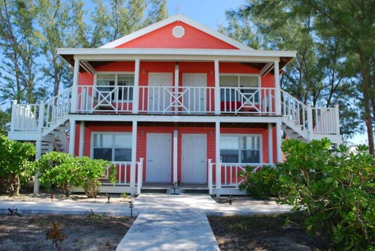 The Red Building with four rooms, two king bedrooms upstairs and 1 double room and 1 king/single room downstairs.  Every room has an en-suite bath and an ocean view. The Red Building with four rooms, two king bedrooms upstairs and 1 double room and 1 king/single room downstairs.  Every room has an en-suite bath and an ocean view.