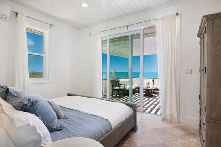 Bedroom with a king bed and a sweeping ocean view