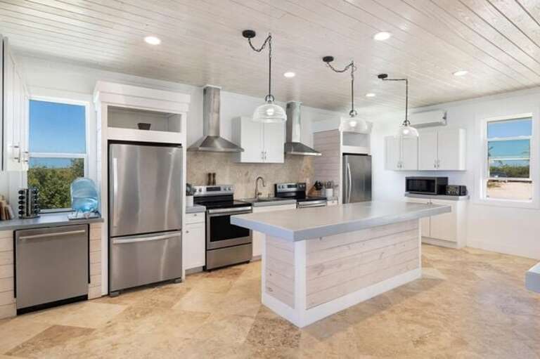 Ocean view caterer's kitchen features two refrigerators and two ranges