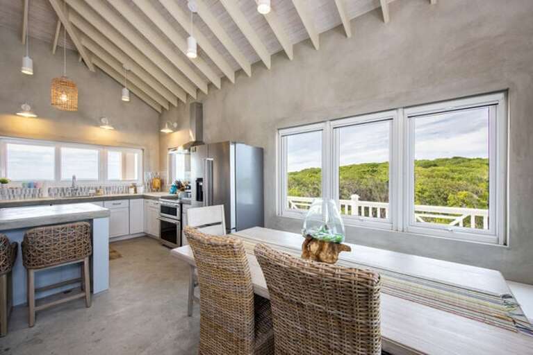 The dining table seats six to eight comfortably with a lovely ocean view