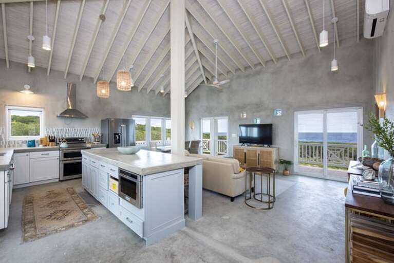 The great room features an 18-foot vaulted ceiling and stunning ocean views throughout.