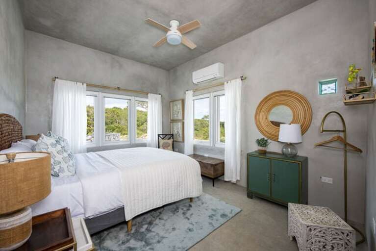 The Sea Glass bedroom has a queen bed, an ocean view, and a blue theme.
