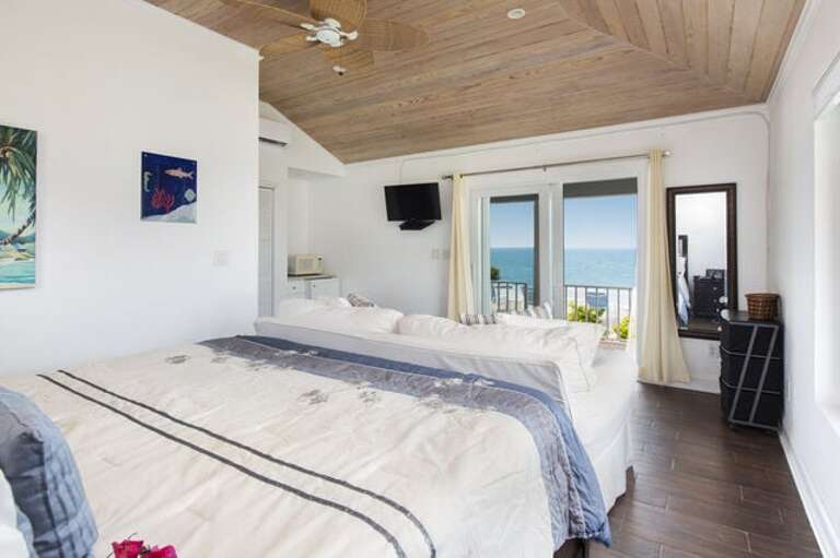 First of two master bedroom suites in the guest cottage.  Each has an ocean view, a king bed, a queen sofa bed, and an en-suite bath.