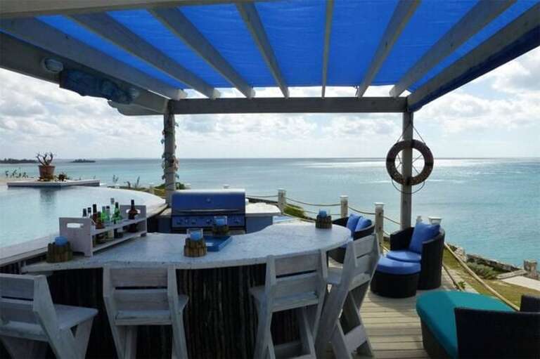 Oceanfront covered bar area beside the pool
