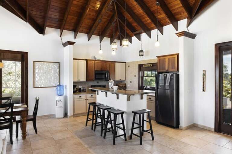 Modern island kitchen with additional seating.