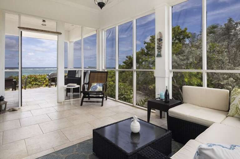 Screened porch with ocean views.