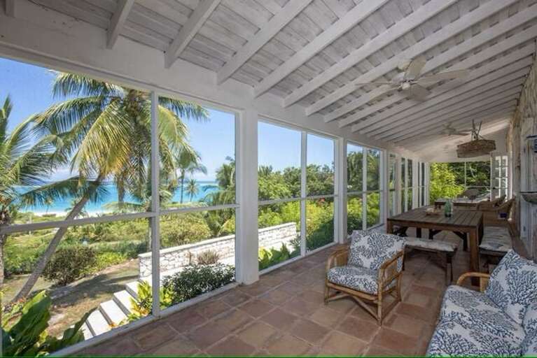 Screened porch with areas for lounging and dining. Screened porch with areas for lounging and dining.