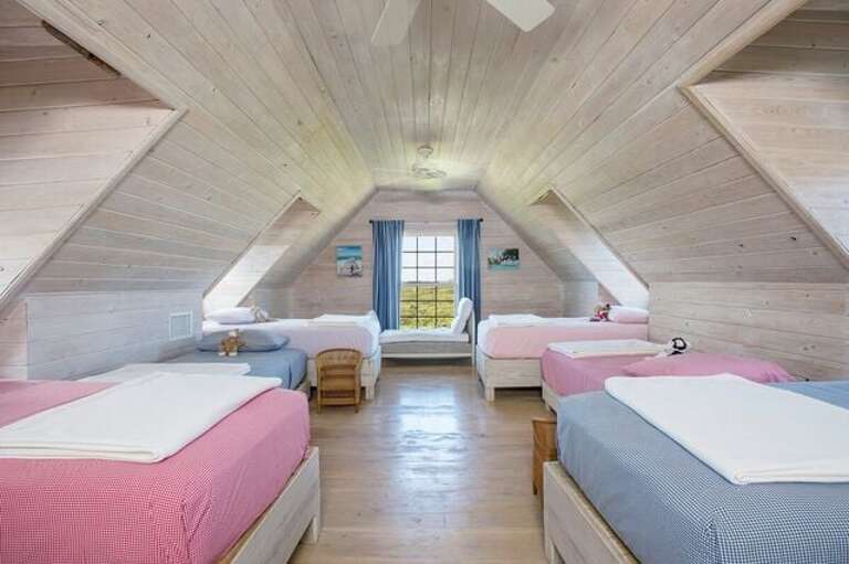 Large finished attic has 6 single beds, plus a living area and en suite bathroom.