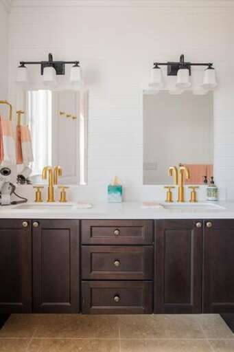 Bath with double sinks and walk in shower.