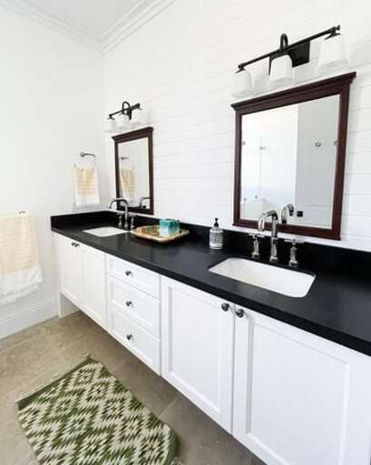 Bath with double sinks, and walk in shower.