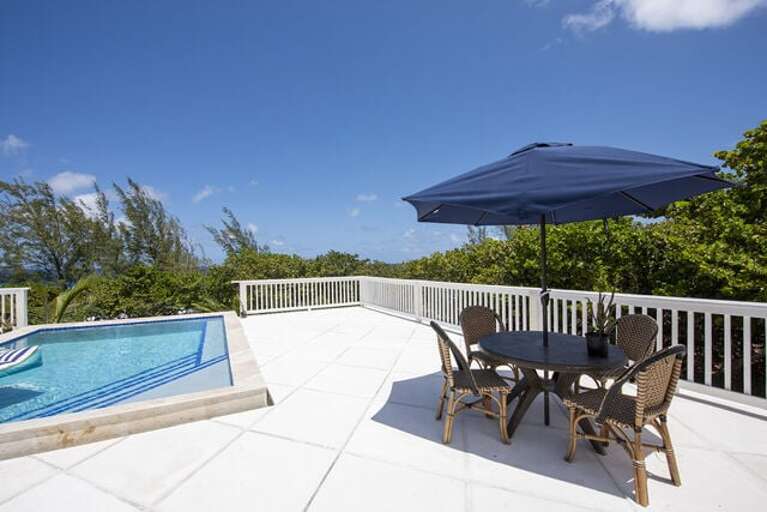 The patio is furnished for dining and lounging