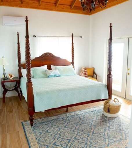 Upper level master bedroom with king size bed and ocean views Upper level master bedroom with king size bed and ocean views