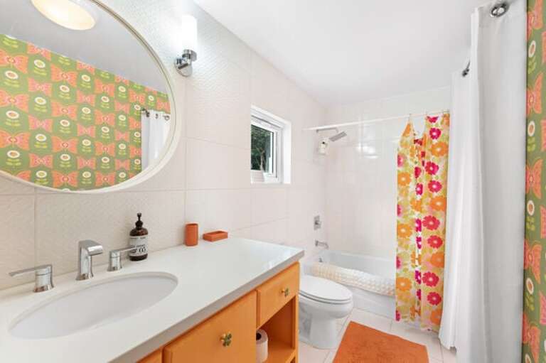 First floor bath off twin bedroom with shower/tub combination.