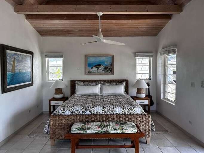 Master Suite Cottage includes a sitting area, desk workspace, a double sink bathroom with a tub and separate tile shower.