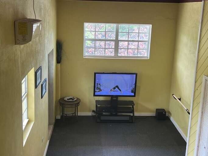 Lounge room with padded floor for yoga/exercise activities. Lounge room with padded floor for yoga/exercise activities.