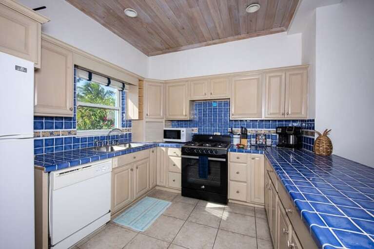 The ocean-view kitchen is fully equipped with refrigerator/freezer, electric range and oven, microwave, and dishwasher.