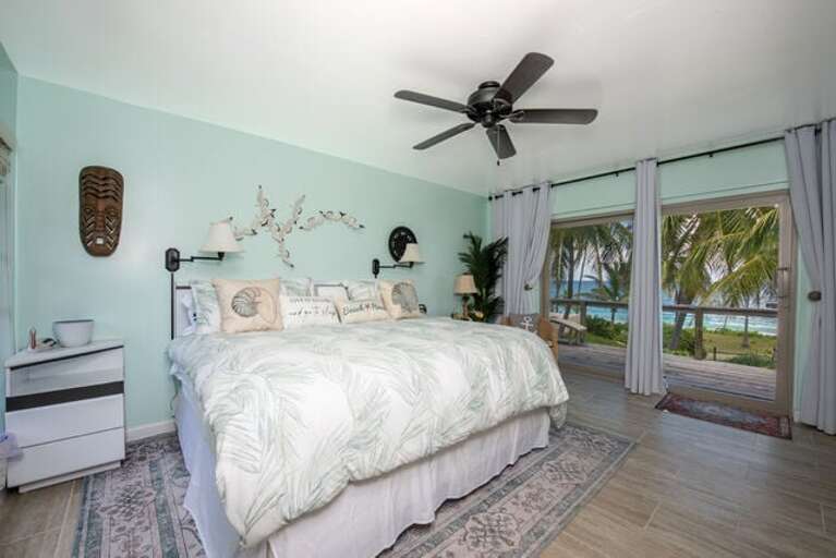 First guest bedroom with king bed, ocean view, and en-suite bath.