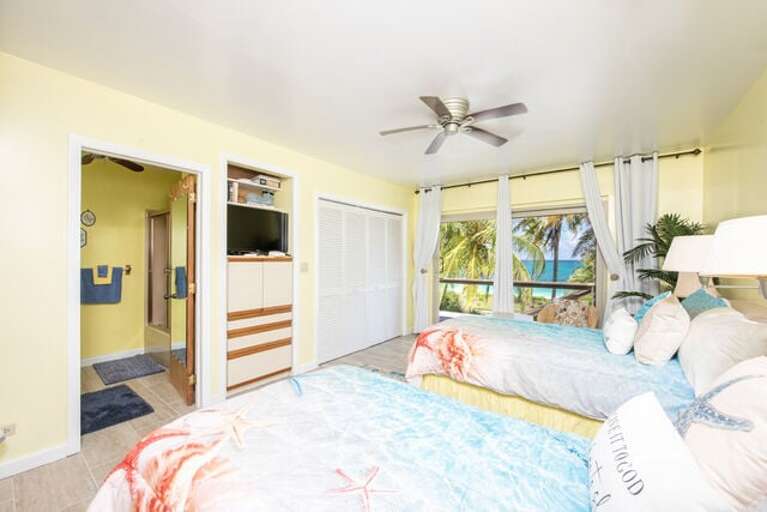 Second guest bedroom with twin beds, ocean view, and en-suite bath.