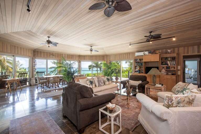 The sitting area is furnished with sofas and armchairs facing the sea.