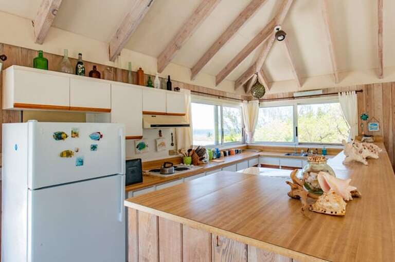 The kitchen is equipped with fridge, oven, cooktop and microwave The kitchen is equipped with fridge, oven, cooktop and microwave