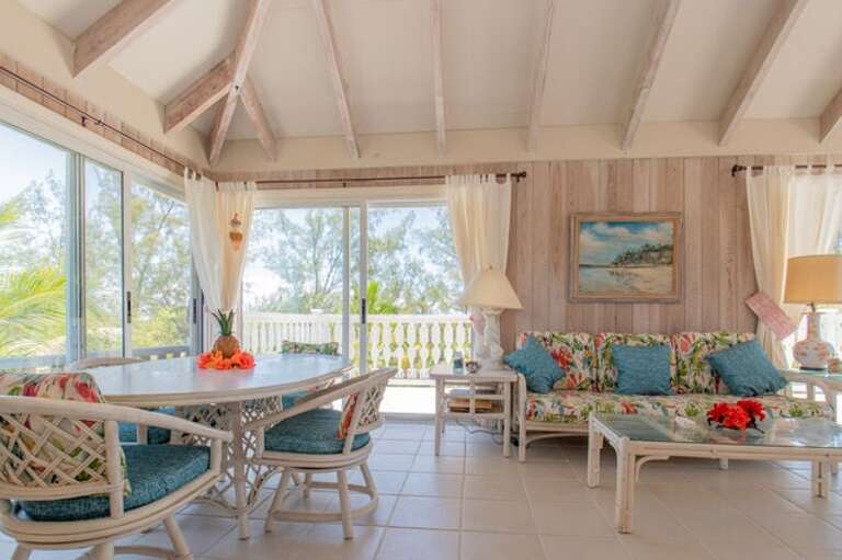 Living area surrounded by sliding glass doors and windows Living area surrounded by sliding glass doors and windows