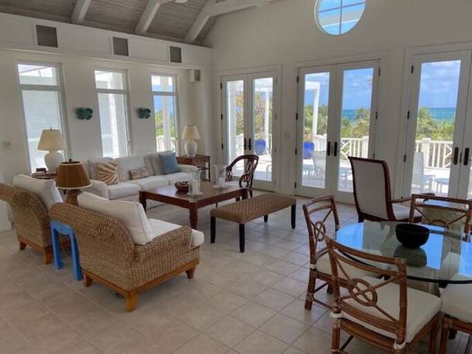 The great room's large seating area includes a games table and overlooks the ocean terrace The great room's large seating area includes a games table and overlooks the ocean terrace