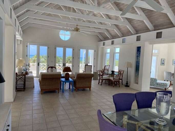 Note the great room is not air conditioned; myriad windows and doors around the room's perimeter provide cross ventilation, supplemented by two large ceiling fans. Note the great room is not air conditioned; myriad windows and doors around the room's perimeter provide cross ventilation, supplemented by two large ceiling fans.