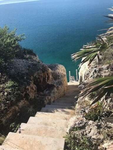 Steps cut out of limestone cliff going down to Caribbean Steps cut out of limestone cliff going down to Caribbean