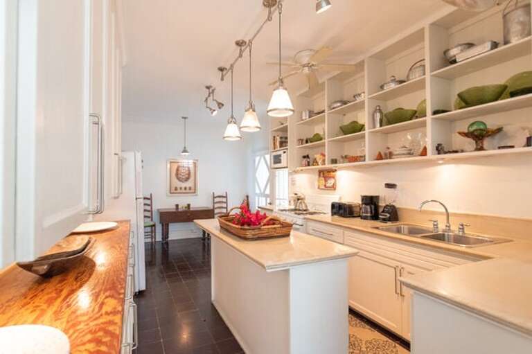 The stunning updated kitchen with an oversized island comes completely equipped