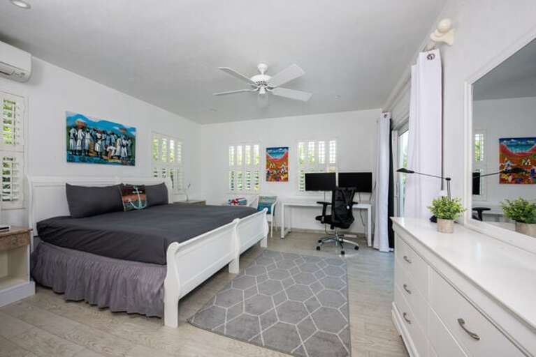 Bedroom Four with a king bed, en-suite bath, and a large sliding glass door leading to the west deck.   A TV is ordered and will be in place soon.