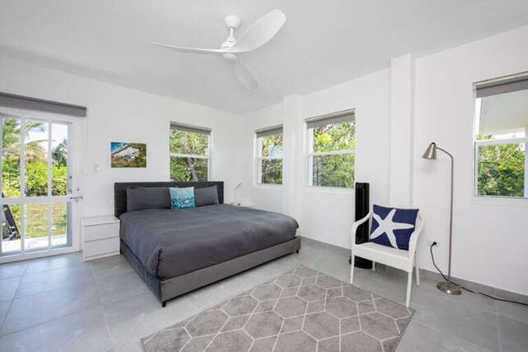 Bedroom Three has a king bed, an en-suite bath, and a partial ocean view.  This bedroom also has a TV.