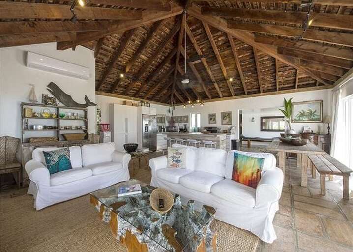Great room features two walls of glass looking out over the beach and ocean