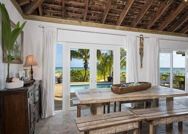 The ocean-view dining room seats eight at the table and four more at the island