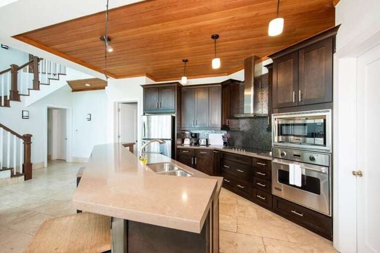 Fully equipped modern kitchen with stainless steel appliances.