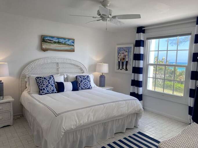 The Master bedroom, with en-suite full bath, is furnished with a king bed.