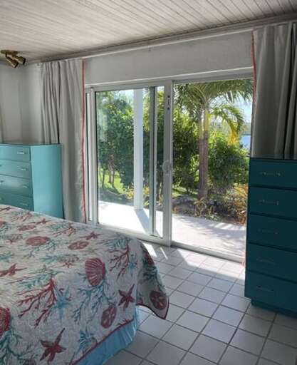 The Master Bedroom has sliding glass doors opening onto a patio that overlooks Savannah Sound and the backyard.