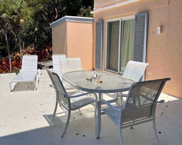 Patio is furnished for both lounging and dining