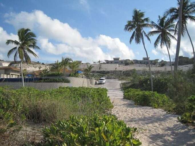 View of the hilltop villas from the beach. (Villas are above the white SUV)