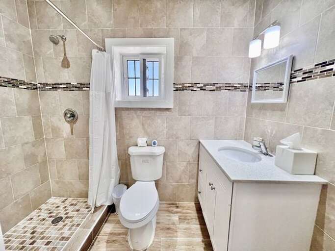 Stylish en suite bath with walk-in shower.