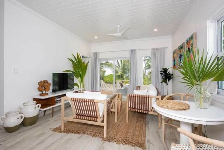 The great room opens onto a large oceanfront porch furnished for lounging and dining.
