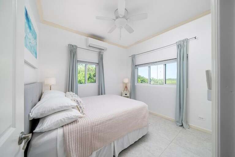 Guest bedroom 1 with a queen bed and a view of Kemp's creek.  The two guest bedrooms share a full bath.