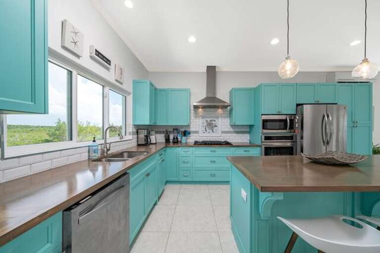 Luxurious modern kitchen finished in stainless steel and polished wood.