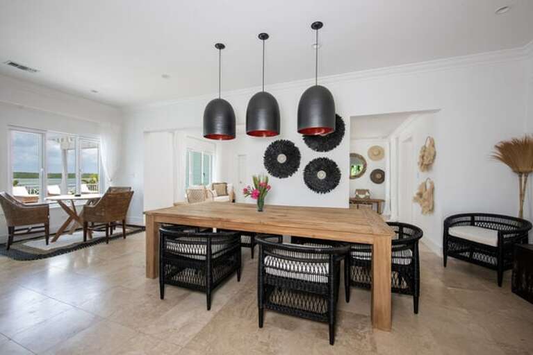 Dining area with windows that frame the picturesque Savannah Sound.