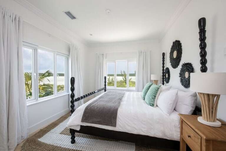 First guest room, a mini-master, beckons with a king-sized bed and spectacular views of Savannah Sound.