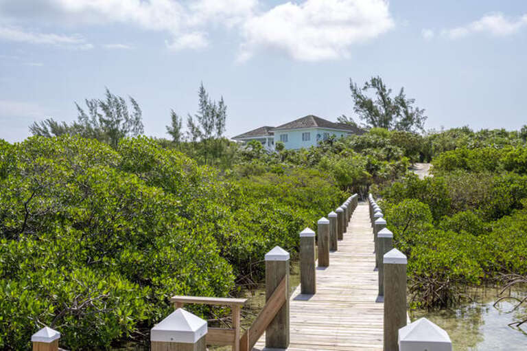 Perched on a hill overlooking the enchanting Savannah Sound.