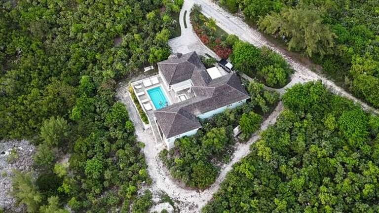 Turtle Pointe on Savannah Sound, a newly remodeled luxury home with a private pool and a private boat dock, a short walk from Windermere's famous miles-long pink-sand beach.