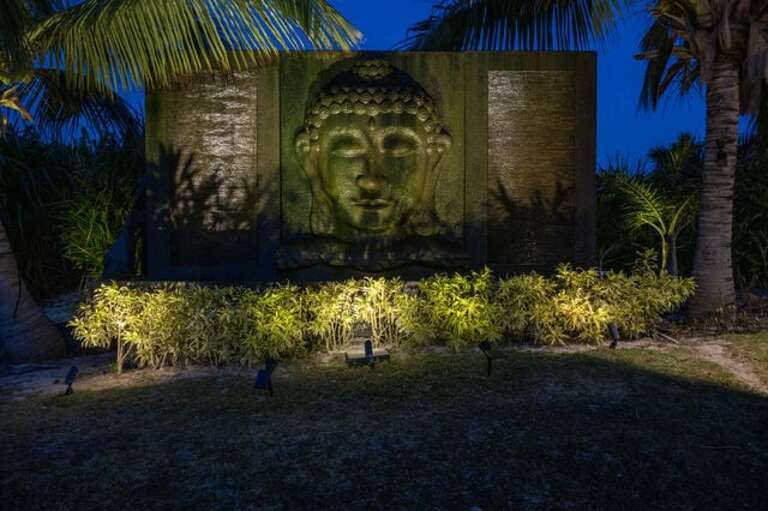 A 12 x 8 foot Zen-inspired Buddha water fountain imported from Bali overlooks this magnificent pool area and bestows its serenity on the courtyard.